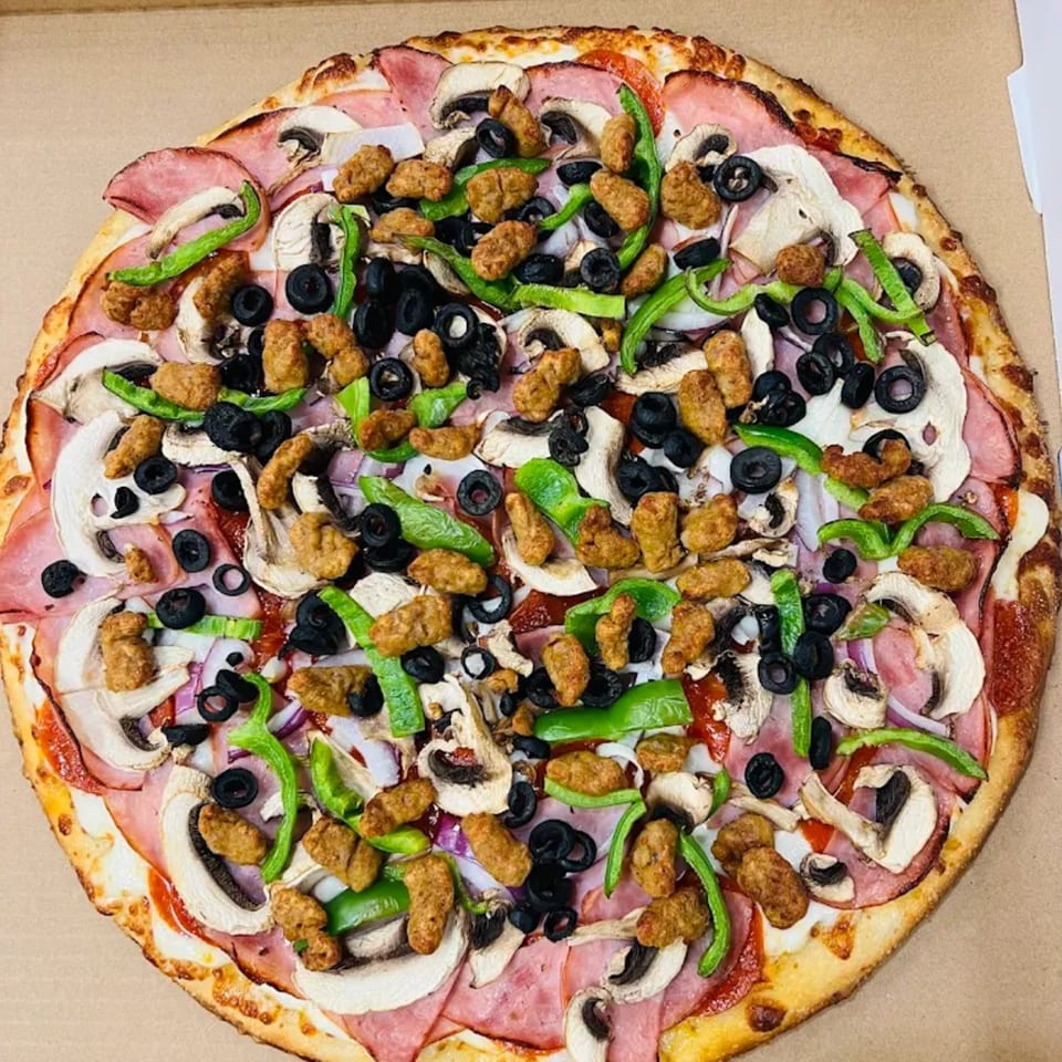 H and H Bar Grill's pizza, loaded with ham, mushrooms, green peppers, black olives, and sausage.